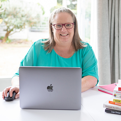 Catherine smiling in front of a laptop
